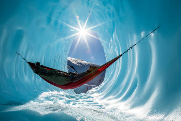 istock Ice climber rests in hammock inside ice cave in the Alaskan wilderness 1141261007