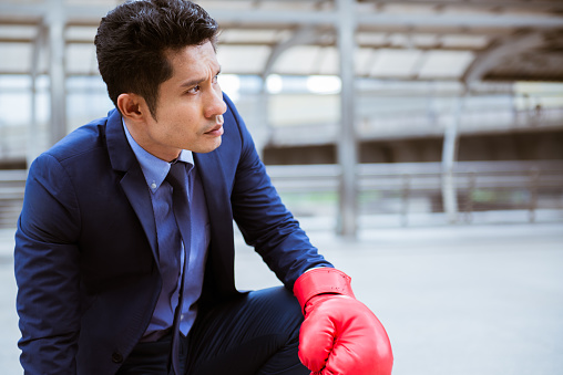 Businessman wear boxing glove looking to the target