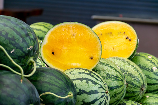 Many watermelon is sold in the fruit market.