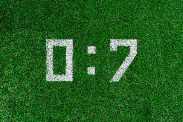 istock The white numerals one and zero painted on the green grass, soccer score 1141269085