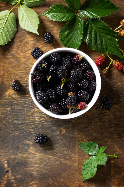 istock Berries ripe blackberries on kitchen wooden table. Top view flat lay background, copy space. 1141270219