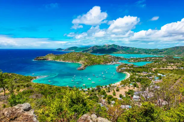 Beautiful bright and colorful aerial view of English harbor, Shirley Heights in Antigua, Caribbean. Landscape with blue sky and white clouds.