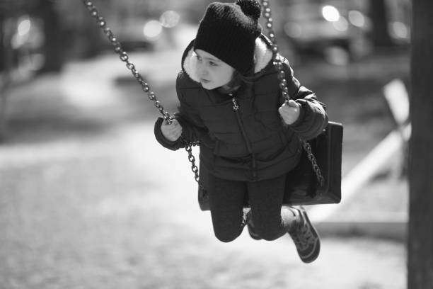 istock Little girl on a swing 1141278123