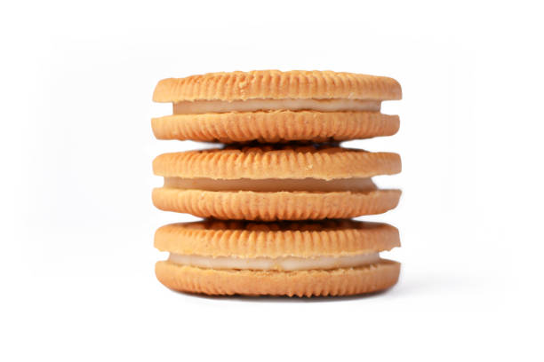 istock Three stacked cookies filled with white cream isolated on white background 1141280296