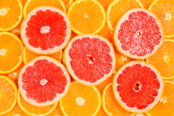 istock Slices of oranges and a grapefruits as a background. 1141281360