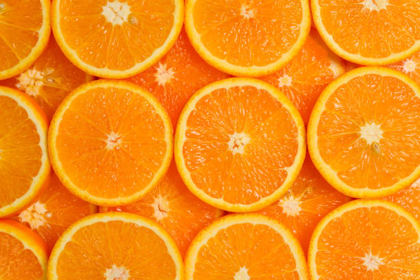 istock Slices of oranges as a background, top view. 1141281361