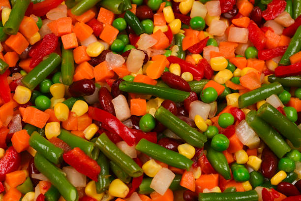 istock Sliced vegetables, corn, beans, peas, carrots, sweet peppers background. 1141281373