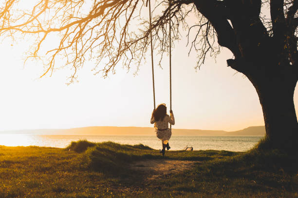 istock girl swinging on a swing 1141281549