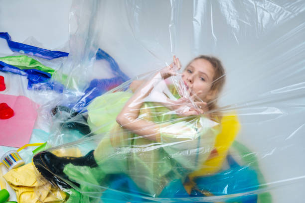 istock Model wearing black leather boots posing with many plastic 1141288490