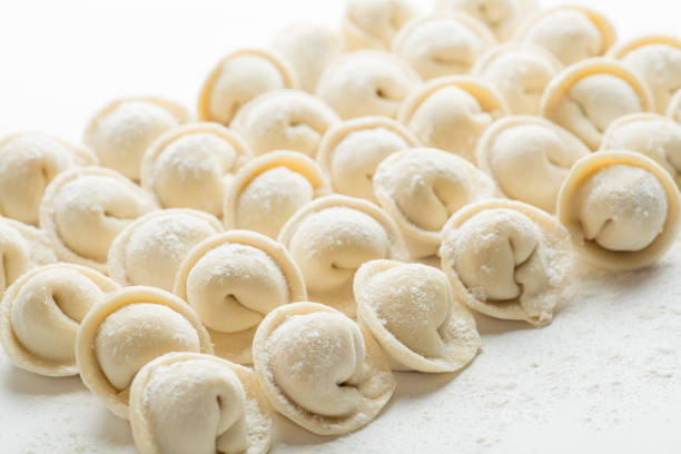 rows of frozen ravioli on a white background. Lots of Isolated Dumplings stock photo