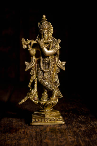 istock Krishna statue on wooden background 1141289077
