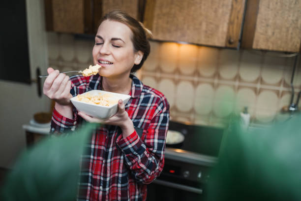 istock Beautiful woman eating breakfast from a bowl 1141289145