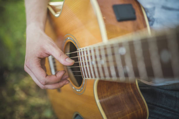 istock Playing acoustic guitar outdoors 1141293548