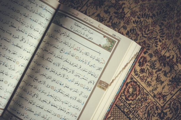 istock The Holy Quran on praying carpet. Flat lay view 1141293738
