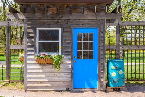 Photo of Rustic garden shed with bright blue door