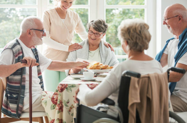 istock Happy seniors having a cake in a nursing home 1141294242
