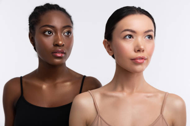 istock Women with hair buns having different skin color but same equality 1141294357
