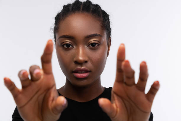 istock Beautiful dark-skinned woman showing her hands while posing 1141294423