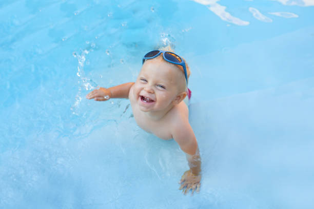 istock Cute child, playing with inflatable boat in pool 1141295856