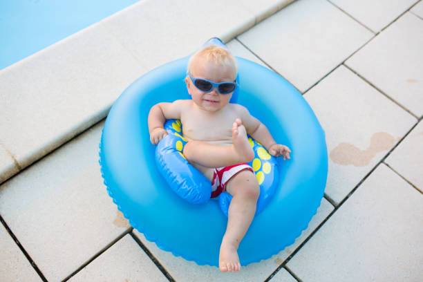 istock Cute child, playing with inflatable boat in pool 1141295948