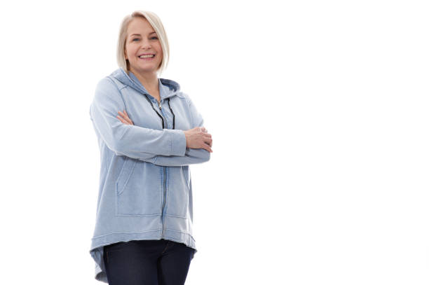 istock Attractive middle aged woman with folded arms on white background 1141299080