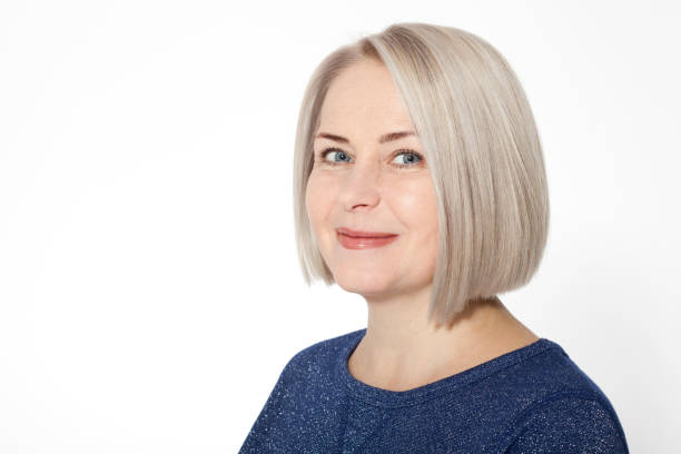 istock Attractive middle aged woman with folded arms on white background 1141299084