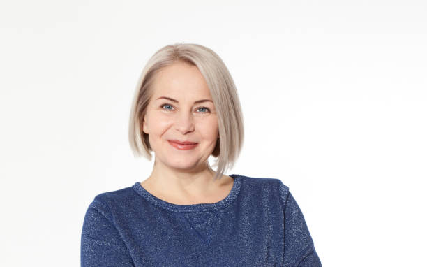 istock Attractive middle aged woman with folded arms on white background 1141299095
