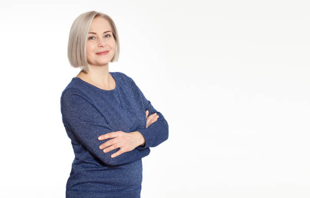 istock Attractive middle aged woman with folded arms on white background 1141299098