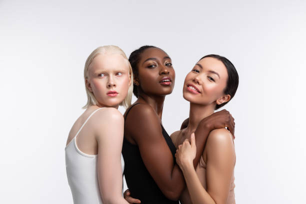 istock Three women with different skin color posing for diversity issue 1141299379