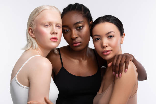 istock African-American woman standing between her light-skinned friends 1141299385