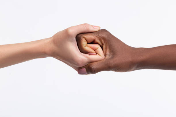 istock Two women with different skin color shaking their hands 1141299417