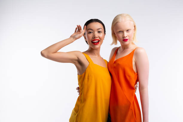 istock Blonde-haired woman hugging her beaming friend with red lips 1141299446