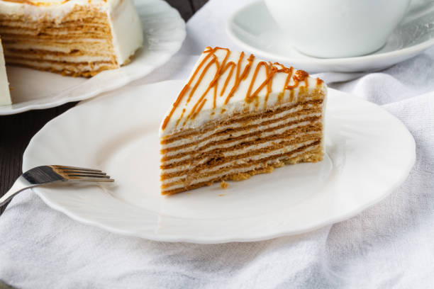 istock Slice of layered honey cake. Russian cake Medovik with walnuts 1141299657