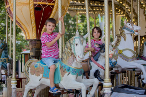 istock Children going on Merry Go Round, kids play on carousel 1141299870