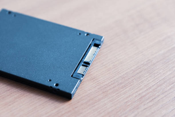 istock solid-state drive at wooden table. ssd for desktop or laptop upgrade hardware. 1141301296