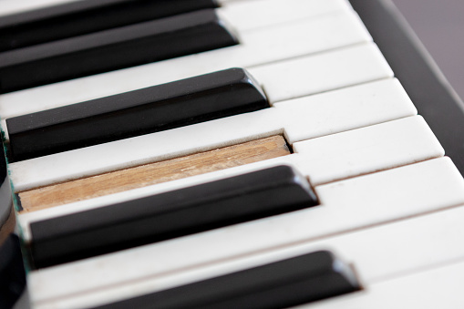 broken piano key.  abandoned musical instrument keyboard . dramatic scene.