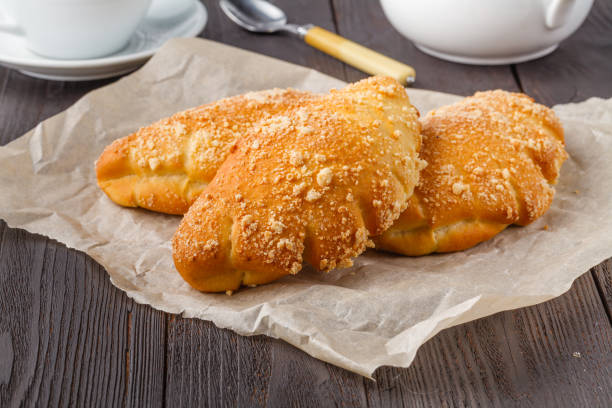 istock Biscuit rolls filled with jam with powdered sugar on top on plate over wooden table 1141301556