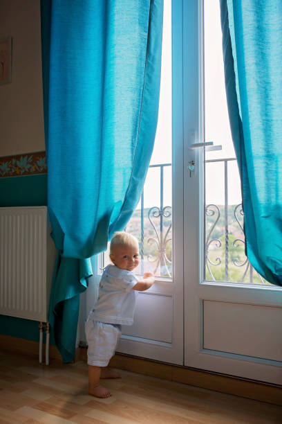 istock Baby boy, child, playing with books at home 1141302602