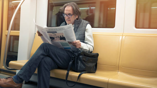 istock Man reading newspaper in the metro train 1141303708