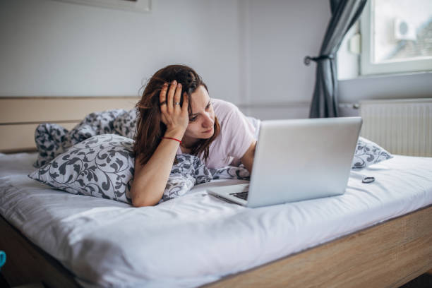 istock Woman is using laptop in her bed 1141303835