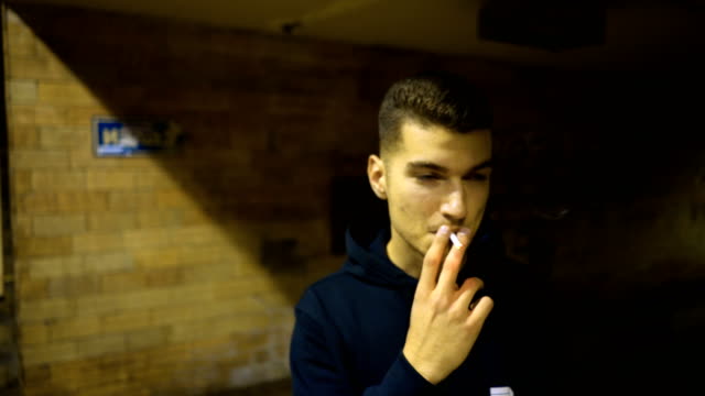 Teenage boy smoking cigarette