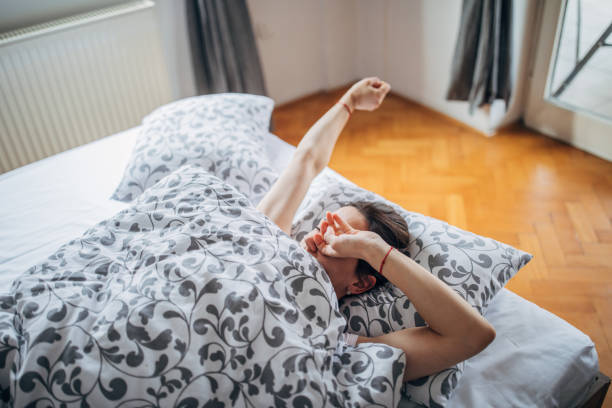 istock Sleepy woman is rubbing her eyes after waking up 1141304016