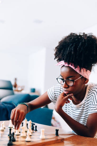 istock Young afro descendant teenager playing chess 1141305111