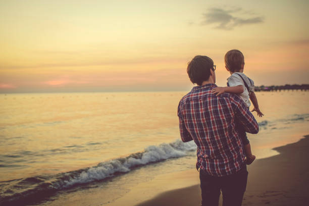 Father with son playing on the beach