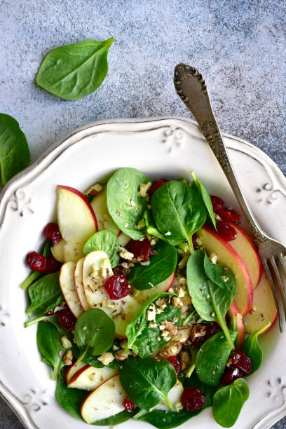 istock Vegan spinach salad with apple, dried cranberry and walnut 1141309052