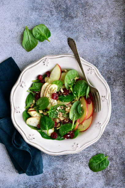 istock Vegan spinach salad with apple, dried cranberry and walnut 1141309053