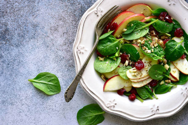 istock Vegan spinach salad with apple, dried cranberry and walnut 1141309066