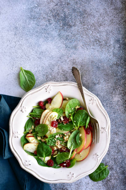 istock Vegan spinach salad with apple, dried cranberry and walnut 1141309067