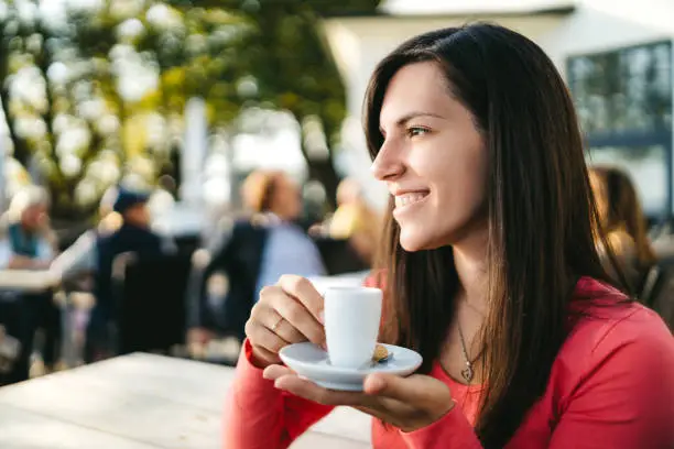 Young beautiful woman is drinking coffee in a suburban Hamburg café