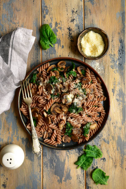 istock Whole wheat fusilli pasta with mushroom and spinach 1141310093